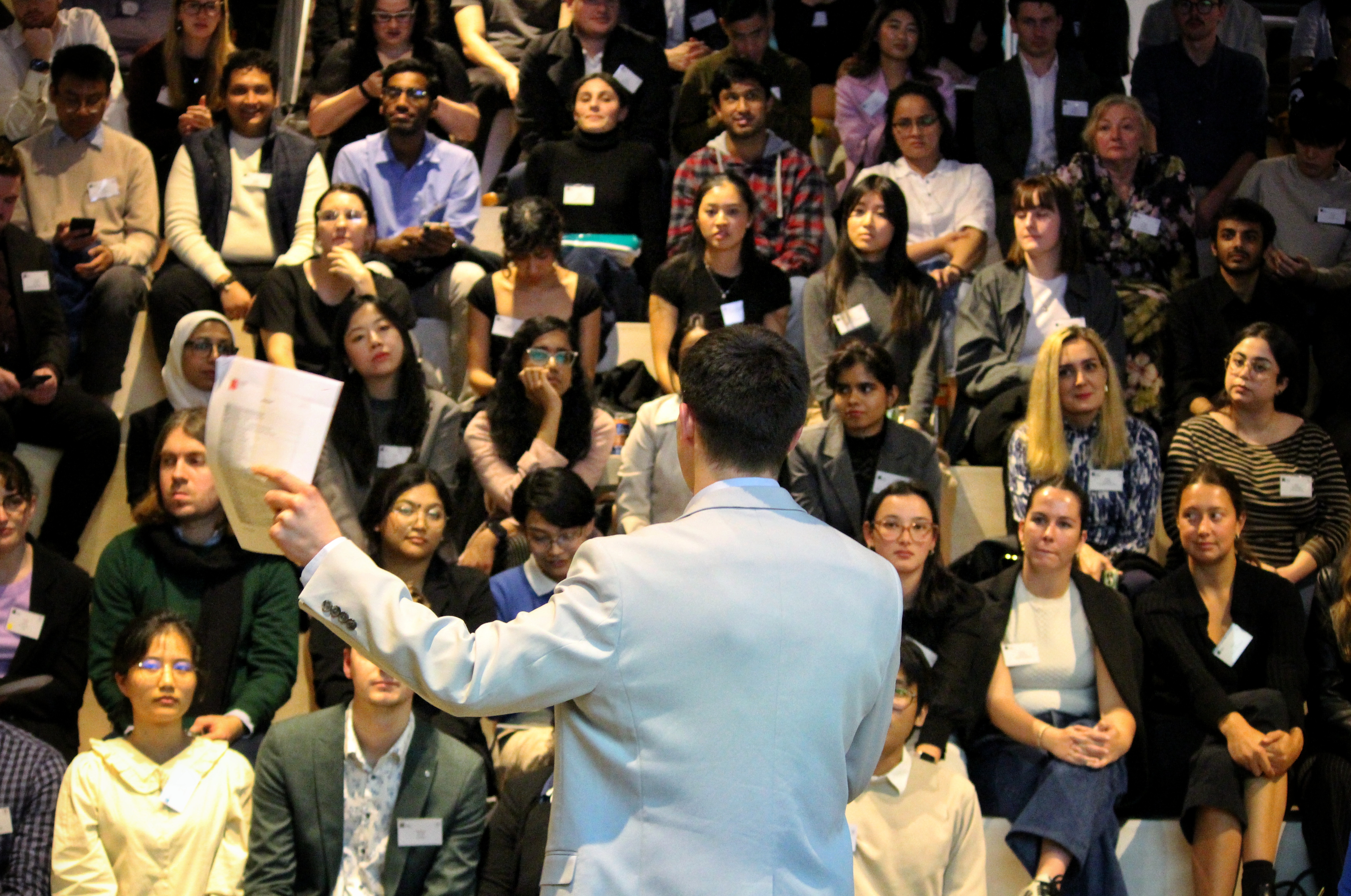 Group of professionals sitting on a couch at a networking and presentation event. 